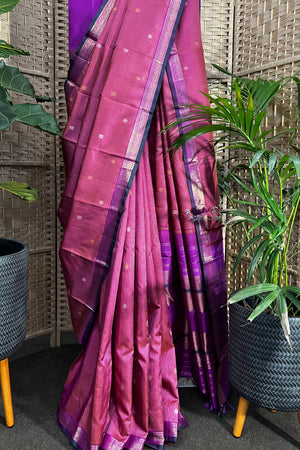 Pinkish purple Kanchipuram Silk saree with zari woven closely to give matt finish to the body with small Zari border
