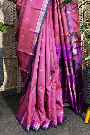 Pinkish purple Kanchipuram Silk saree with zari woven closely to give matt finish to the body with small Zari border