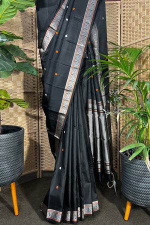 Black handwoven Kanchipuram Silk saree with burnt orange and silver mangaa motifs