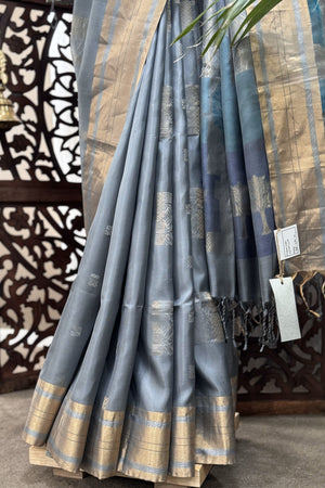 Grey color body with square silver Zari Butis, Cuddy border with sea Green and Blue pallu soft Silk saree