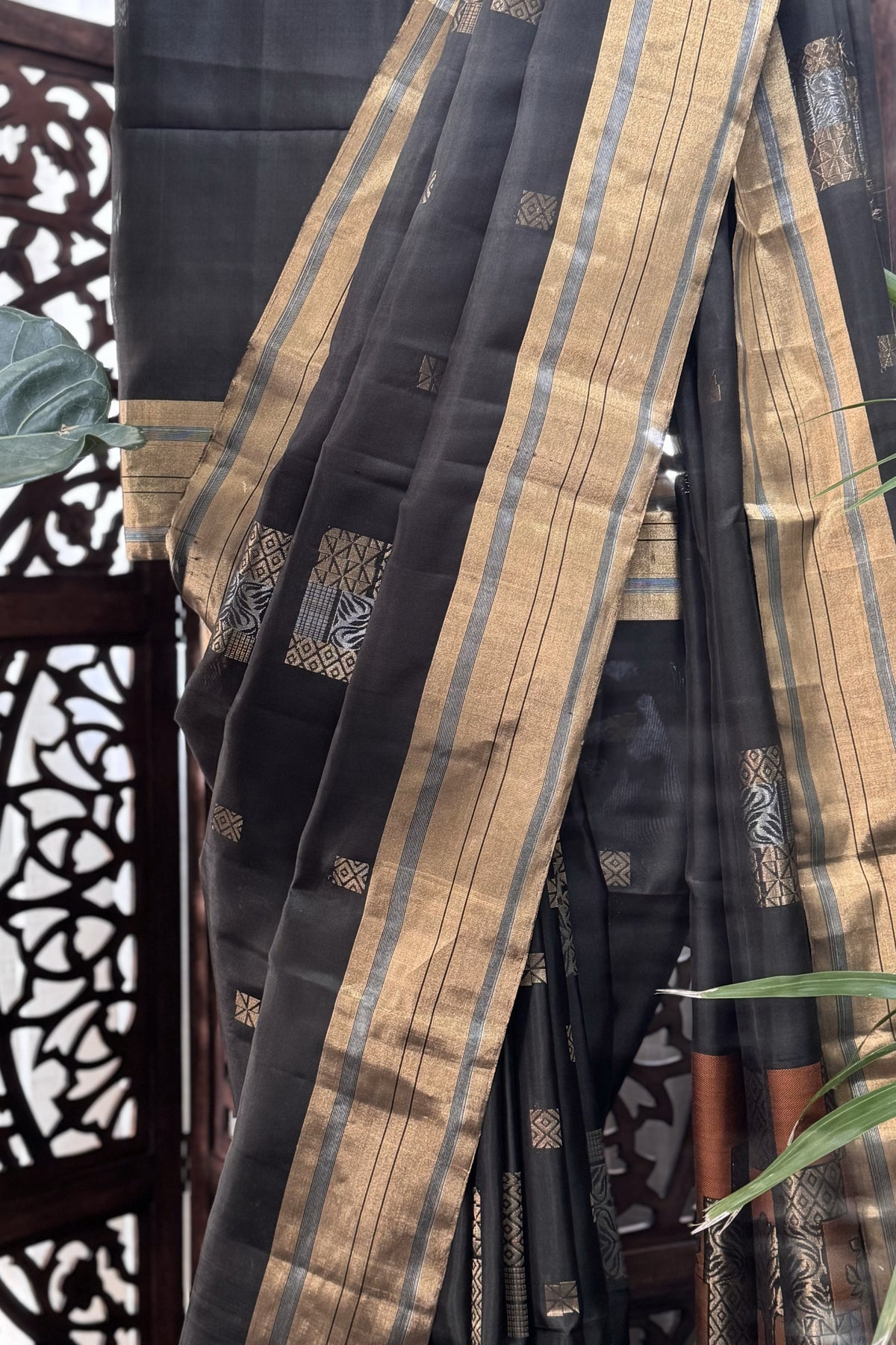 Blackish Green color body with square gold Zari Butis, Cuddy border with Burnt Orange pallu soft Silk saree