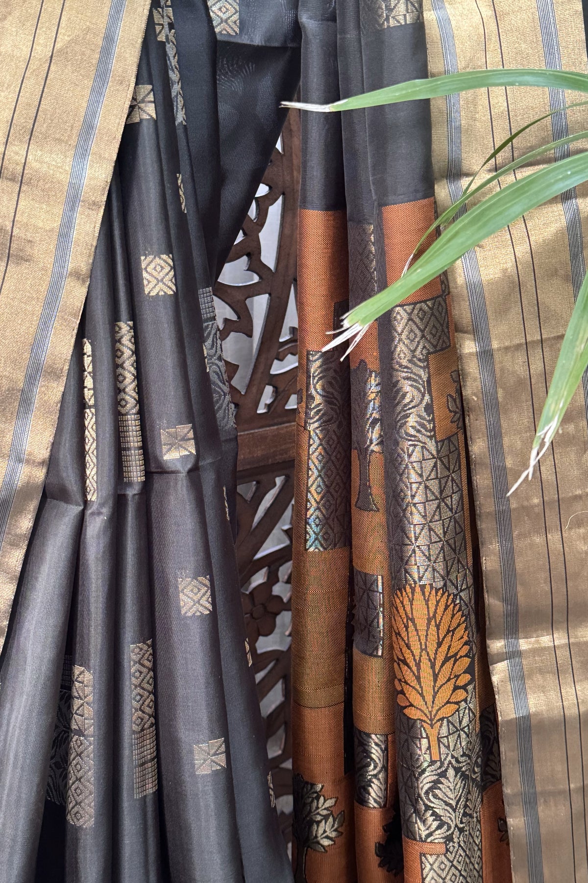 Blackish Green color body with square gold Zari Butis, Cuddy border with Burnt Orange pallu soft Silk saree