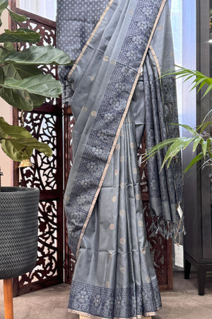 Grey color body with round Zari Butis, Navy Blue Ikkat border and Pallu with Gold Selvedge Soft Silk Saree
