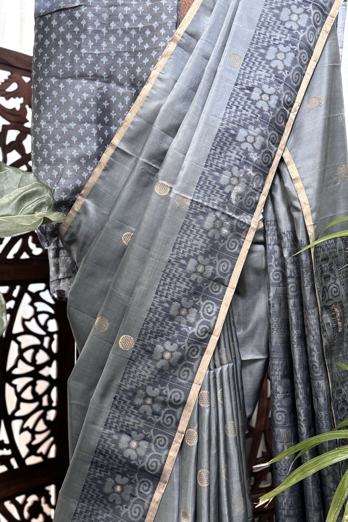 Grey color body with round Zari Butis, Navy Blue Ikkat border and Pallu with Gold Selvedge Soft Silk Saree