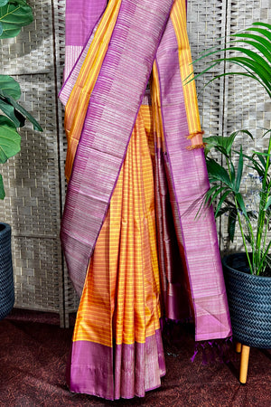 Mustard Kanchipuram saree with horizontal pattern beautifully complemented with stylist contemporary border.