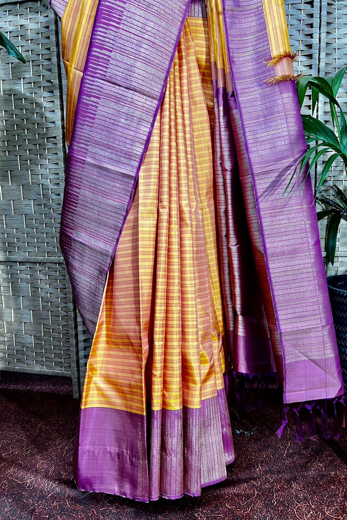 Mustard Kanchipuram saree with horizontal pattern beautifully complemented with stylist contemporary border.