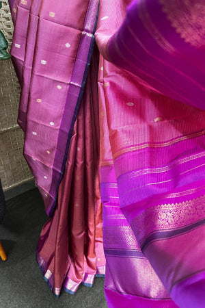 Pinkish purple Kanchipuram Silk saree with zari woven closely to give matt finish to the body with small Zari border
