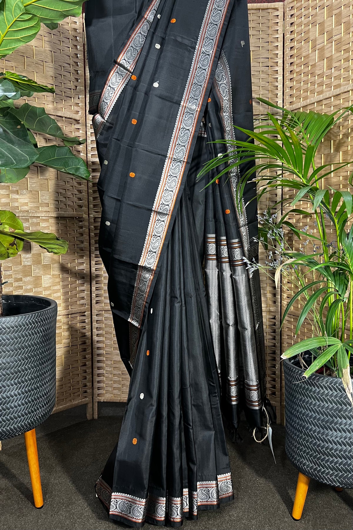 Black handwoven Kanchipuram Silk saree with burnt orange and silver mangaa motifs