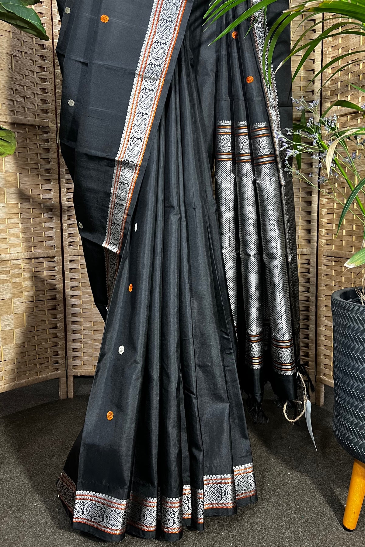 Black handwoven Kanchipuram Silk saree with burnt orange and silver mangaa motifs