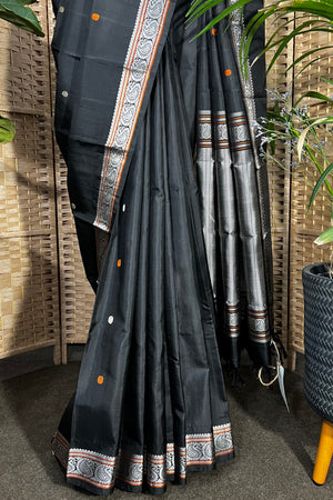 Black handwoven Kanchipuram Silk saree with burnt orange and silver mangaa motifs
