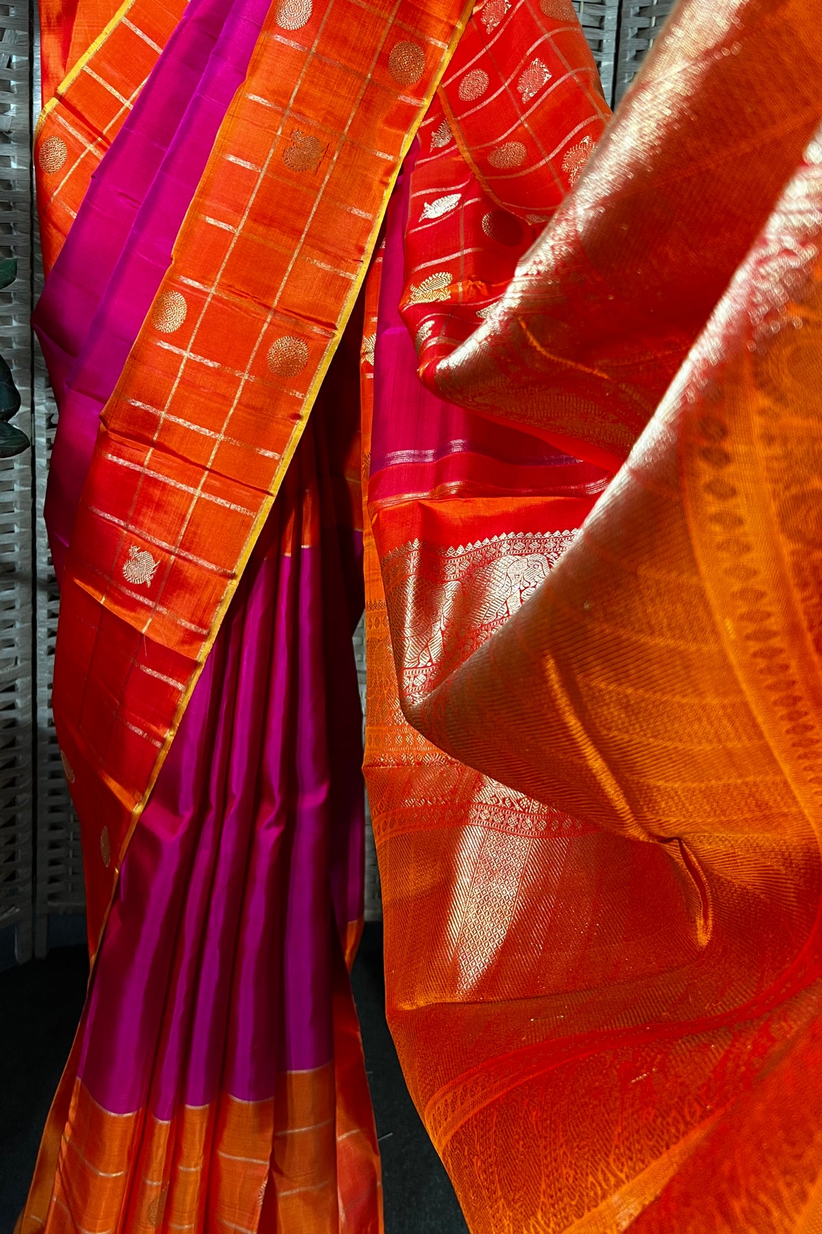Magenta handwoven Kanchipuram Silk saree with wide orange checks border